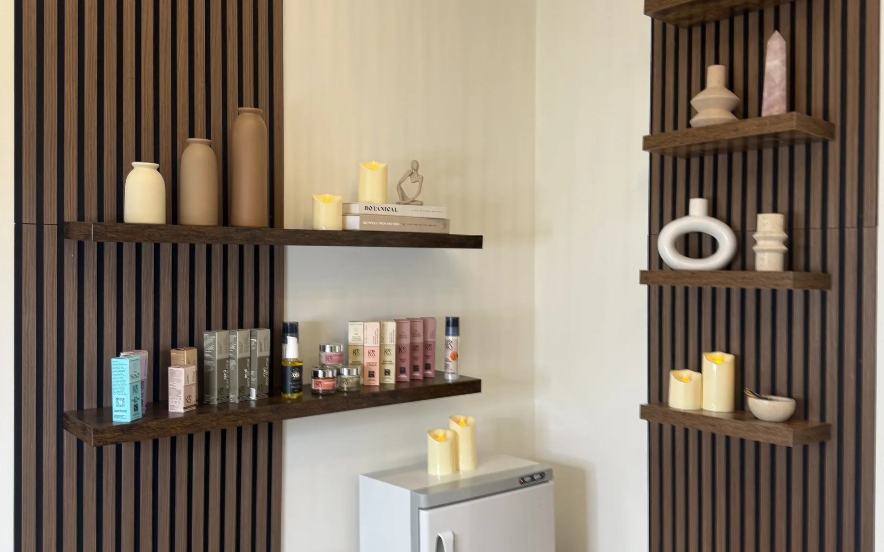Skin Cove treatment room in Grand Rapids with warm wood accents and professional skincare products